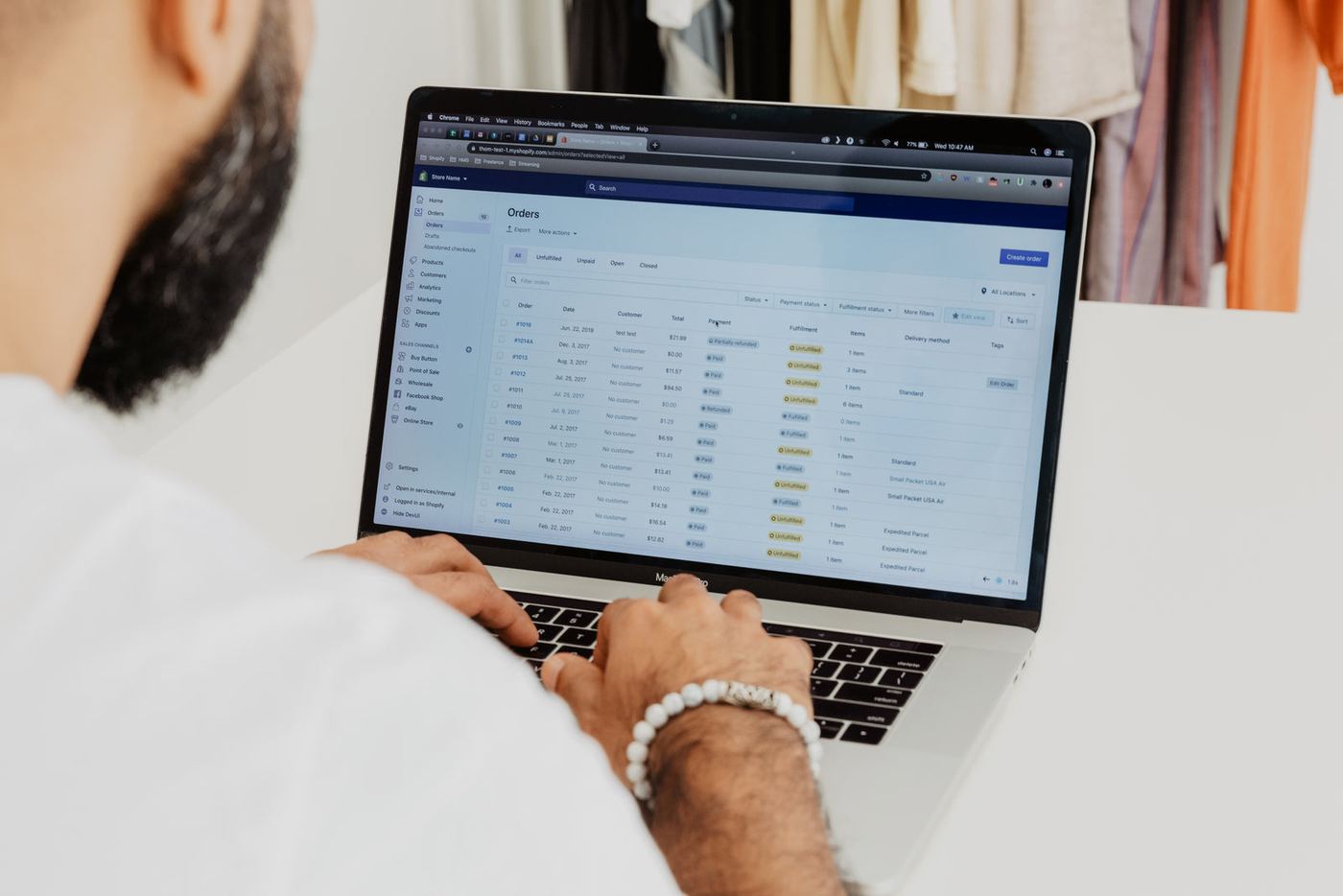 A business owner working through orders on a laptop